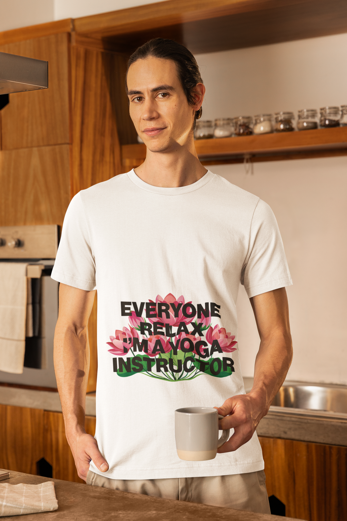 Person wearing a white t-shirt with a yoga instructor message in a kitchen.