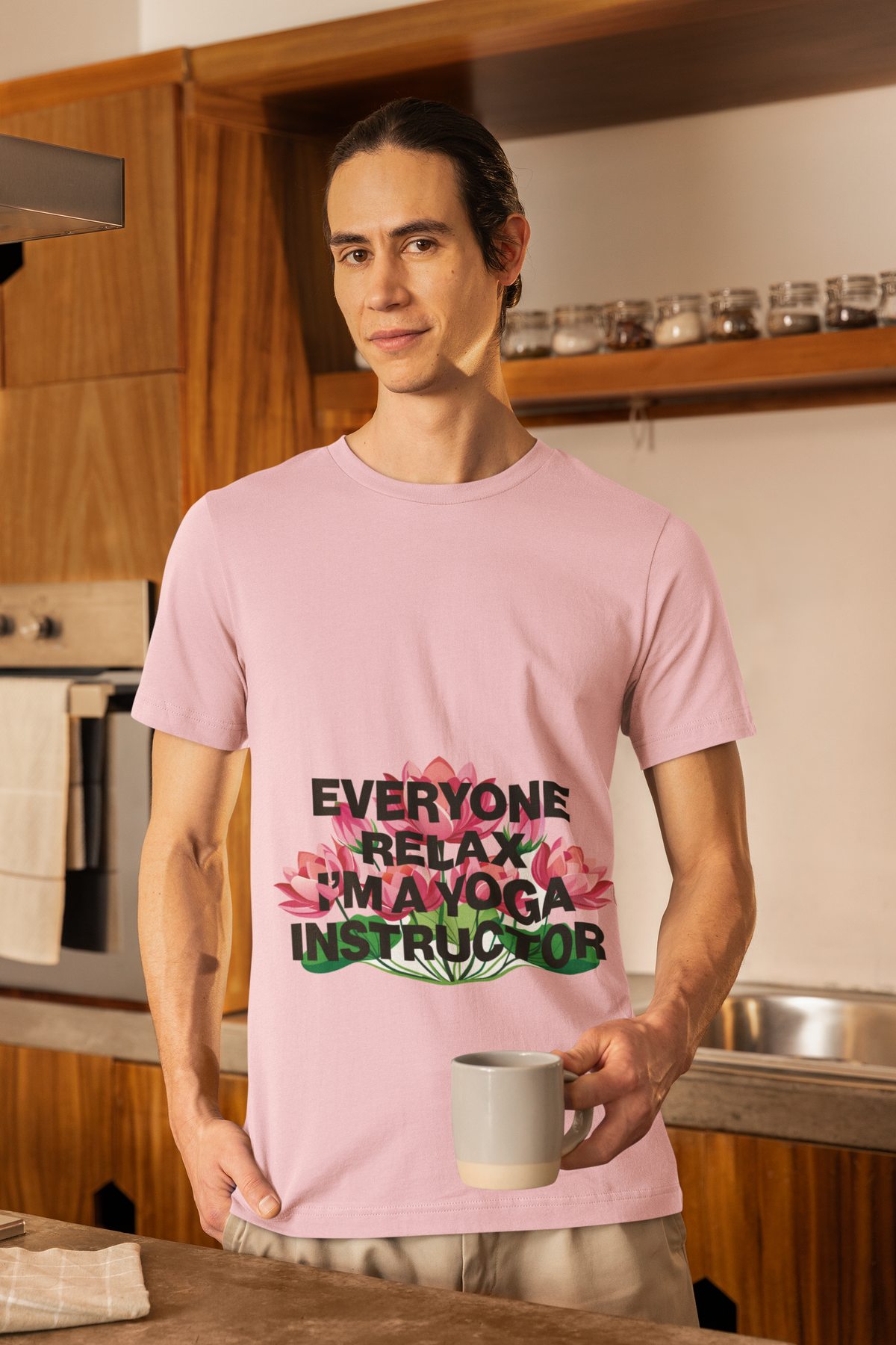 Person wearing a pink t-shirt with text in a kitchen