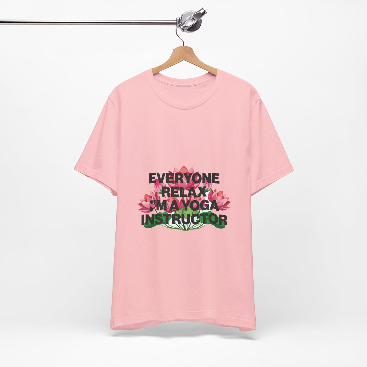 Pink t-shirt with text and flowers on a hanger against a white background