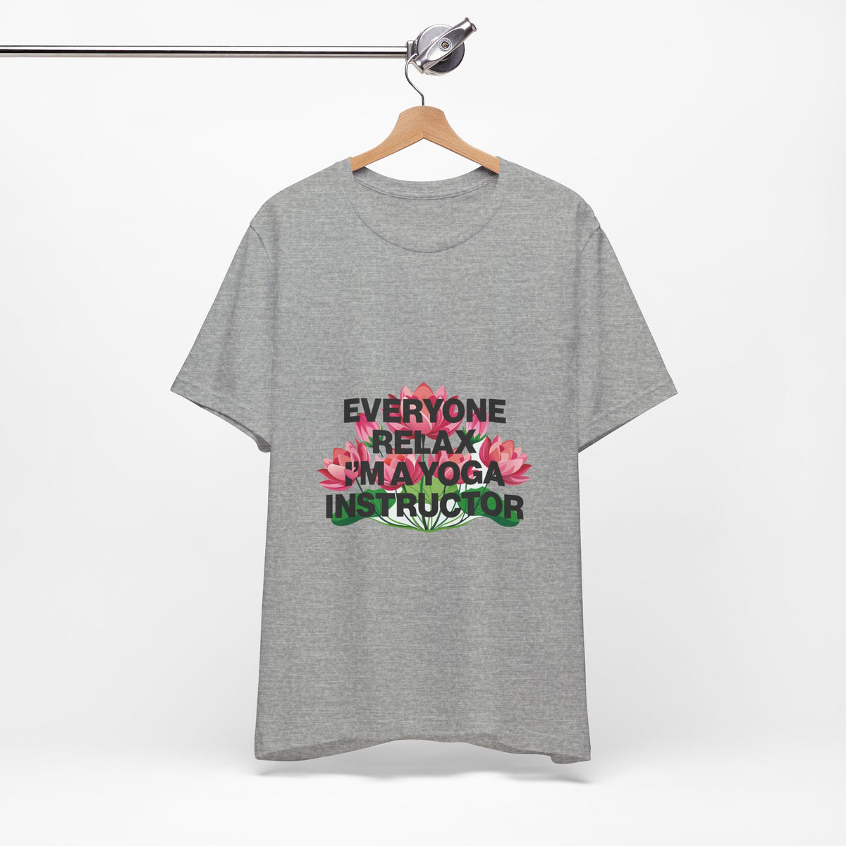Gray t-shirt with a humorous yoga instructor design on a hanger against a white background