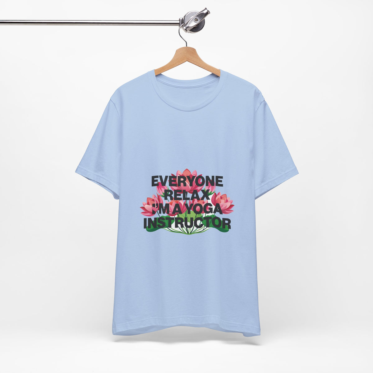 Light blue t-shirt with text and flower graphics on a hanger against a white background